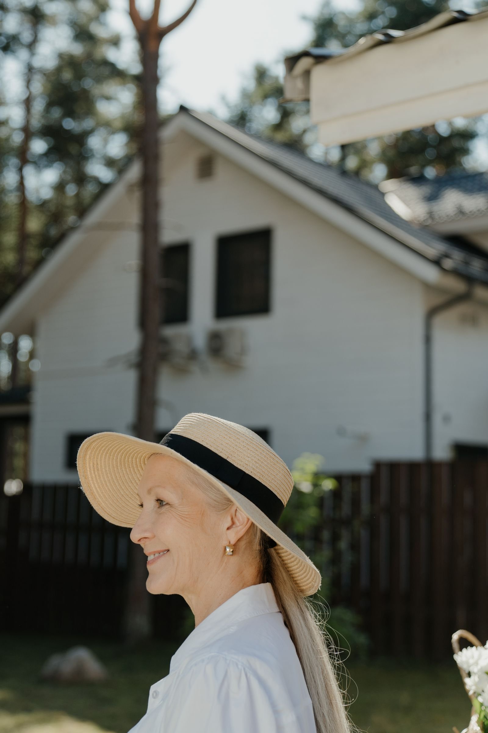 Mature woman wearing a broad-brim sun hat outdoors in natural daylight